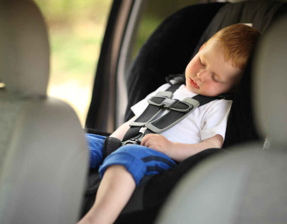 Boy sleeping in child car seat